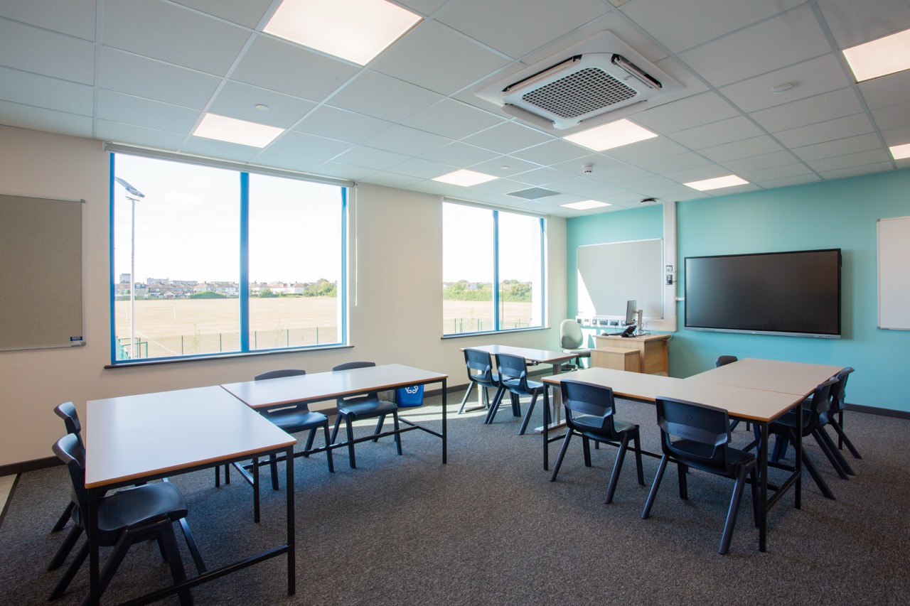 Professionally decorated modern classroom featuring clean paintwork, large windows, LED lighting and an organised furniture layout